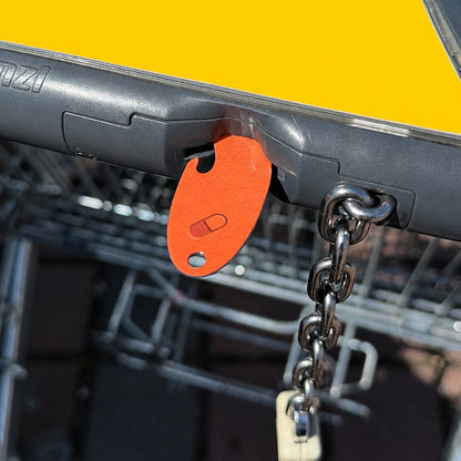 Bitcoin Einkaufswagenlöser in Orange Pill im Münzschlitz eines Einkaufswagens als praktische Alternative zur Münze