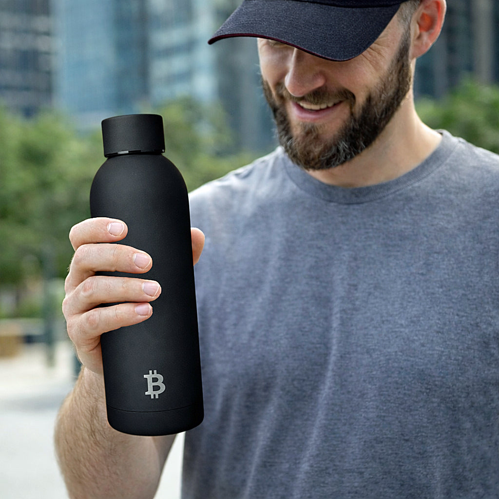 Mann hält Bitcoin Thermoflasche in der Hand im Alltag